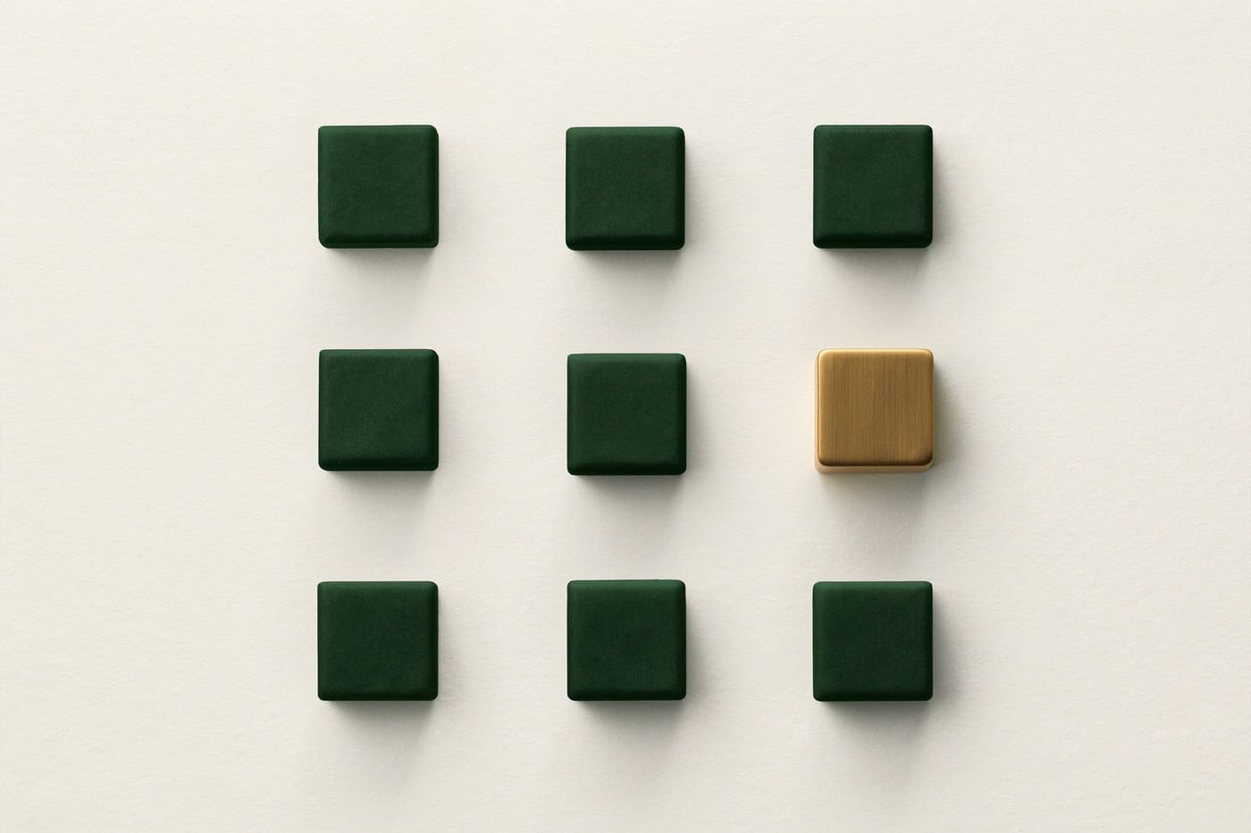 A grid of nine green cubes with one gold cube